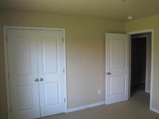 1756 Freedom Way, Montrose, CO 81401 - unfurnished bedroom featuring a closet, baseboards, and light carpet