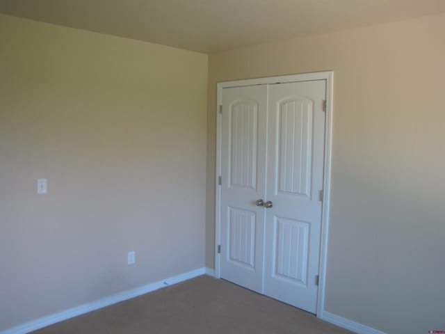 1756 Freedom Way, Montrose, CO 81401 - unfurnished bedroom featuring a closet, carpet, and baseboards