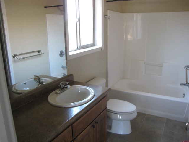 1756 Freedom Way, Montrose, CO 81401 - bathroom featuring toilet, vanity,  shower combination, and tile patterned flooring