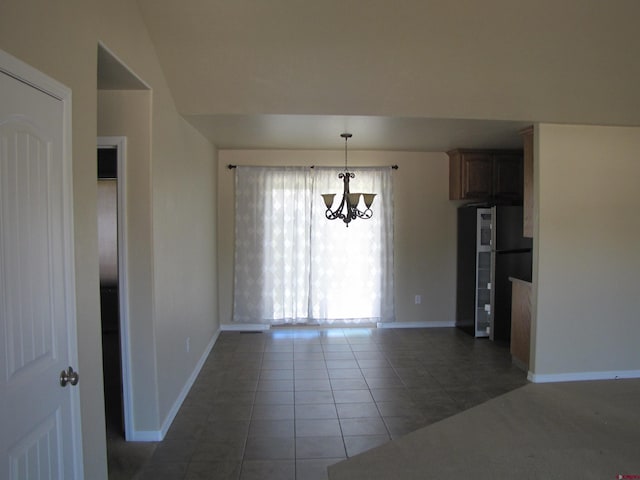 1756 Freedom Way, Montrose, CO 81401 - unfurnished dining area with tile patterned flooring, baseboards, and a chandelier