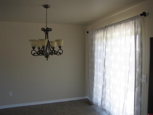 1756 Freedom Way, Montrose, CO 81401 - unfurnished room with a chandelier and baseboards