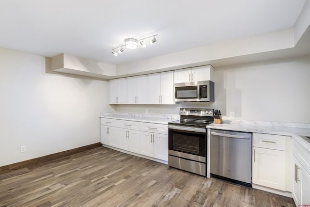 156 Zeligman St, Crested Butte, CO 81224 - kitchen with appliances with stainless steel finishes, wood finished floors, light countertops, and white cabinets