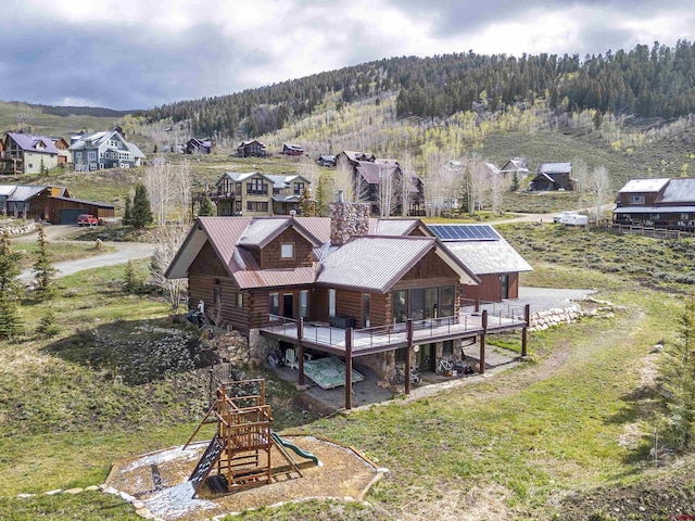 156 Zeligman St, Crested Butte, CO 81224 - back of property featuring log exterior, metal roof, and a wooden deck