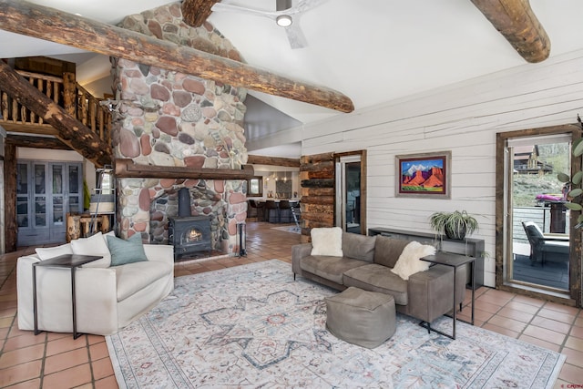 156 Zeligman St, Crested Butte, CO 81224 - tiled living area featuring a wood stove, beamed ceiling, wood walls, and high vaulted ceiling