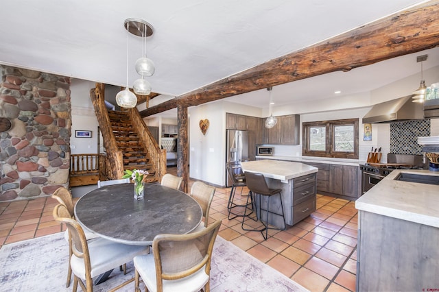 156 Zeligman St, Crested Butte, CO 81224 - dining space featuring stairway, light tile patterned floors, and beamed ceiling