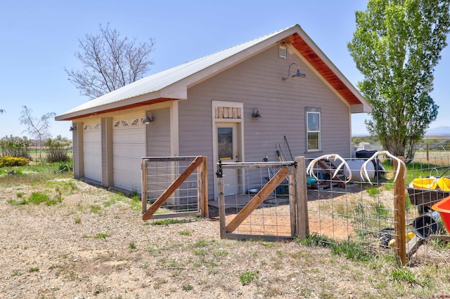 15307 Rd R, Cahone, CO 81320 - back of property with a garage, metal roof, and a gate