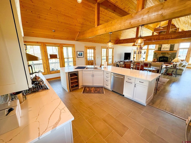 405 Meridian Lake Dr, Crested Butte, CO 81224 - kitchen featuring stainless steel dishwasher, wine cooler, wooden ceiling, white cabinetry, and open floor plan
