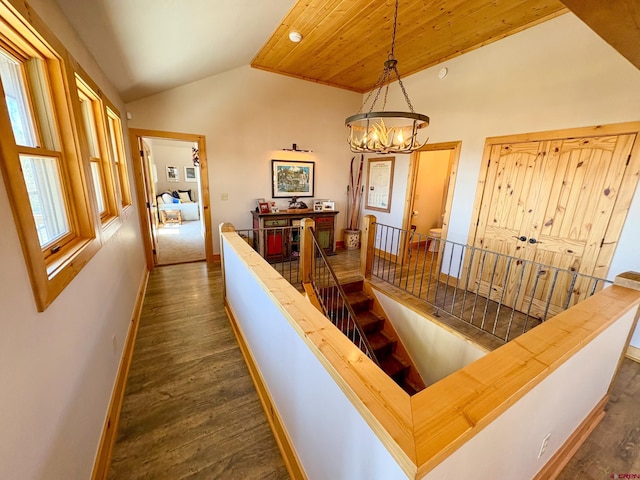 405 Meridian Lake Dr, Crested Butte, CO 81224 - corridor featuring an upstairs landing, vaulted ceiling, dark wood-style floors, a chandelier, and baseboards