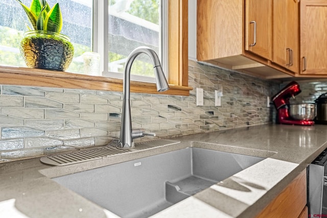 125 Ball Ln, Durango, CO 81301 - kitchen featuring a sink, decorative backsplash, brown cabinets, dishwasher, and light countertops