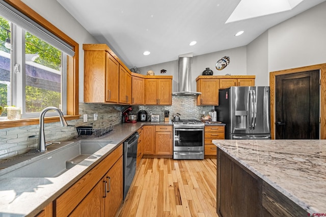 125 Ball Ln, Durango, CO 81301 - kitchen featuring stainless steel appliances, wall chimney range hood, a sink, a skylight, and lofted ceiling