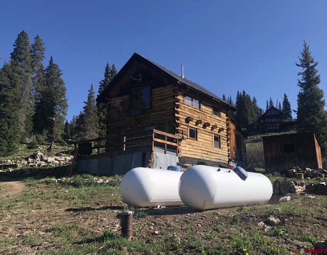 451 9th St, Crested Butte, CO 81224 - view of property exterior with log siding and an outdoor structure