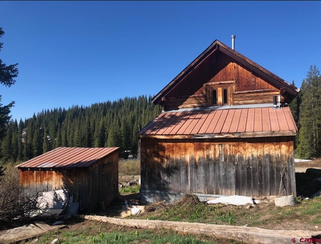 451 9th St, Crested Butte, CO 81224 - view of shed featuring a wooded view