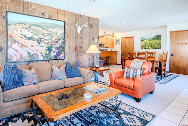 35 Emmons Rd Unit 11, Mount Crested Butte, CO 81225 - tiled living room with wood walls and recessed lighting