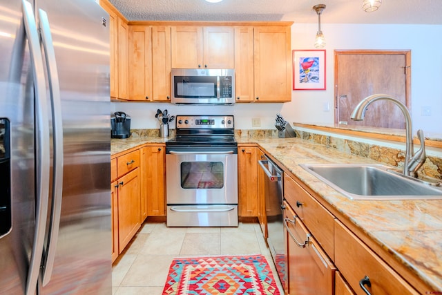 35 Emmons Rd Unit 11, Mount Crested Butte, CO 81225 - kitchen featuring appliances with stainless steel finishes, a sink, light countertops, and light tile patterned floors