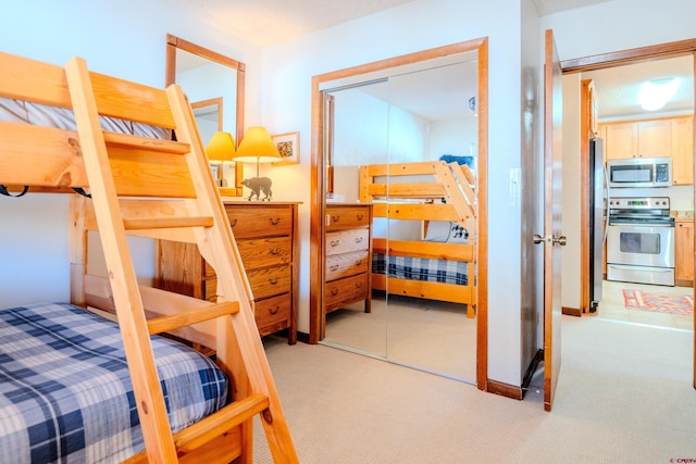 35 Emmons Rd Unit 11, Mount Crested Butte, CO 81225 - bedroom with light colored carpet and freestanding refrigerator