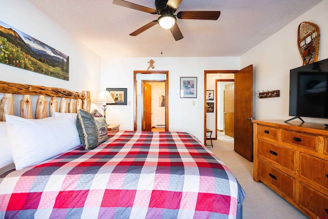 35 Emmons Rd Unit 11, Mount Crested Butte, CO 81225 - bedroom featuring light colored carpet, a textured ceiling, and a ceiling fan