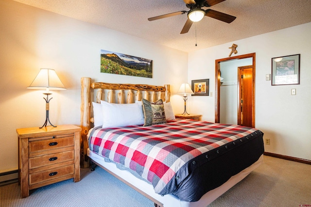 35 Emmons Rd Unit 11, Mount Crested Butte, CO 81225 - bedroom with carpet flooring, baseboards, a textured ceiling, a ceiling fan, and a baseboard heating unit