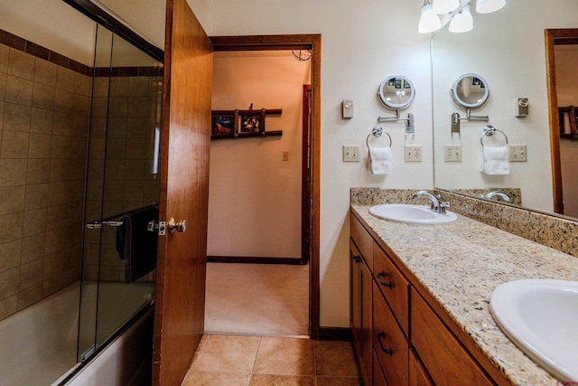 35 Emmons Rd Unit 11, Mount Crested Butte, CO 81225 - bathroom with double vanity, shower / bath combination with glass door, tile patterned floors, and baseboards