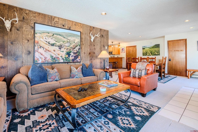 35 Emmons Rd Unit 11, Mount Crested Butte, CO 81225 - tiled living area featuring recessed lighting, wood walls, carpet floors, and a textured ceiling