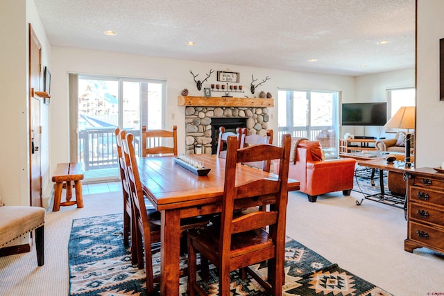 35 Emmons Rd Unit 11, Mount Crested Butte, CO 81225 - carpeted dining space featuring a textured ceiling, healthy amount of natural light, recessed lighting, and a fireplace