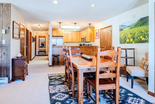 35 Emmons Rd Unit 11, Mount Crested Butte, CO 81225 - dining area with light colored carpet, recessed lighting, and a textured ceiling