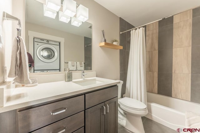 20 Marcellina Ln Unit 104, Mount Crested Butte, CO 81225 - full bathroom featuring estacked washer and dryer, vanity, shower / tub combo, toilet, and tile patterned floors