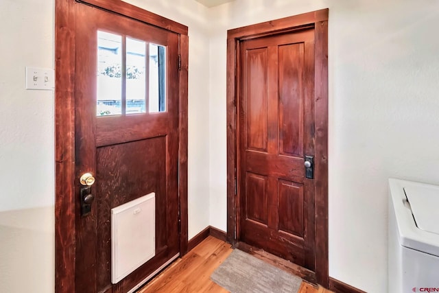 175 NW 4th St, Cedaredge, CO 81413 - entryway featuring light wood-style flooring, baseboards, and washer / dryer
