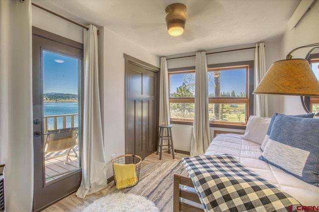 190 Luxury Pl Unit 3, Pagosa Springs, CO 81147 - bedroom featuring a water view, ceiling fan, and light wood finished floors