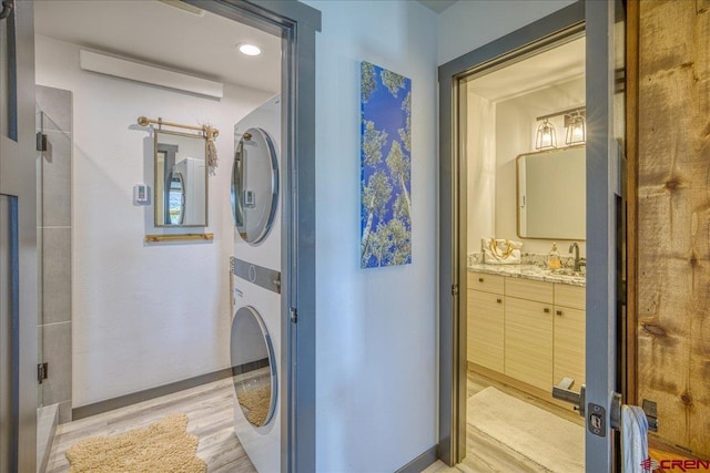 190 Luxury Pl Unit 3, Pagosa Springs, CO 81147 - laundry room with estacked washer and dryer and light wood finished floors