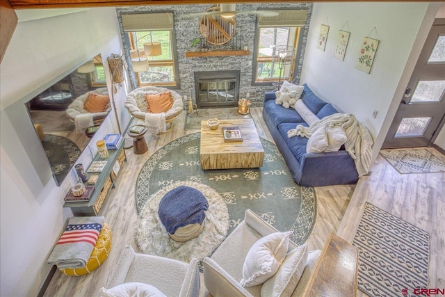 190 Luxury Pl Unit 3, Pagosa Springs, CO 81147 - living area featuring wood finished floors, plenty of natural light, a stone fireplace, and baseboards