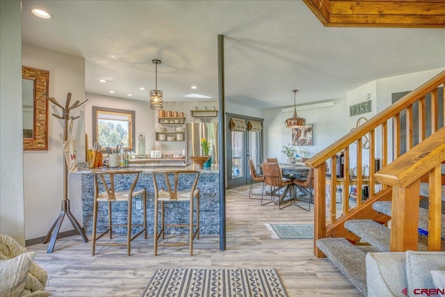 190 Luxury Pl Unit 3, Pagosa Springs, CO 81147 - kitchen with wood finished floors, recessed lighting, stainless steel fridge, pendant lighting, and baseboards