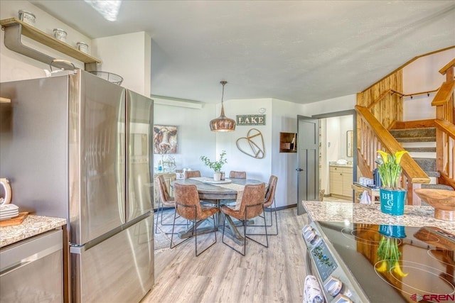 190 Luxury Pl Unit 3, Pagosa Springs, CO 81147 - dining area featuring light wood-style floors, stairs, and a textured ceiling