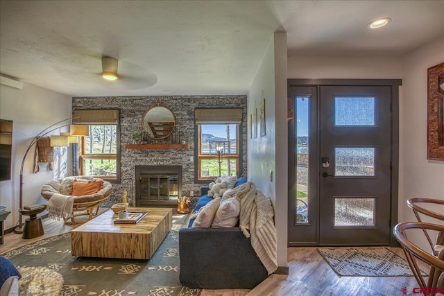 190 Luxury Pl Unit 3, Pagosa Springs, CO 81147 - living room featuring plenty of natural light, wood finished floors, a ceiling fan, and a fireplace