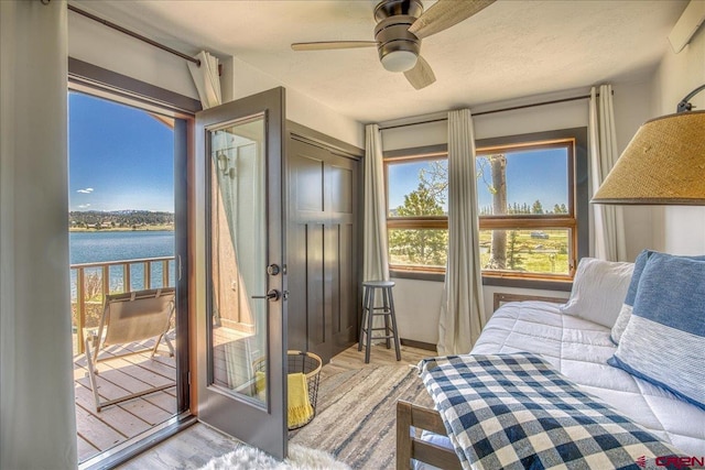 190 Luxury Pl Unit 3, Pagosa Springs, CO 81147 - bedroom featuring a water view, wood finished floors, and a ceiling fan