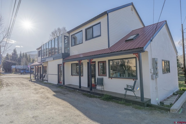 310 Second St, Crested Butte, CO 81224 - view of front of home with a porch, metal roof, and stucco siding