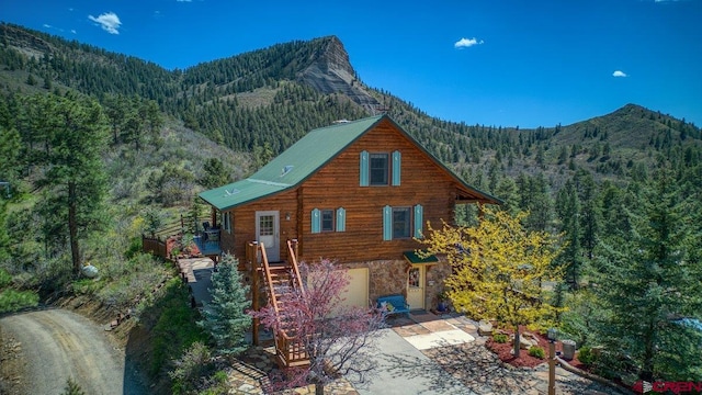 598 Blue Jay Cir, Pagosa Springs, CO 81147 - view of front facade with a wooded view, a mountain view, and stone siding