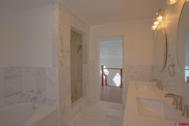 511 E Garland St, La Veta, CO 81055 - bathroom with a garden tub, tile walls, double vanity, a marble finish shower, and marble look tiles