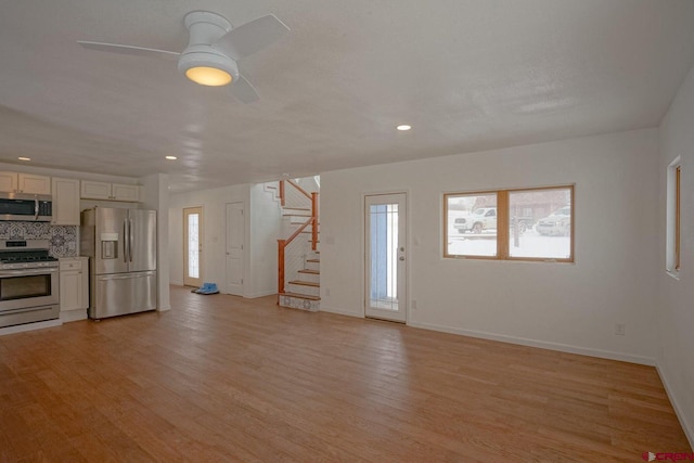 511 E Garland St, La Veta, CO 81055 - unfurnished living room featuring stairway, baseboards, light wood-style flooring, a ceiling fan, and recessed lighting