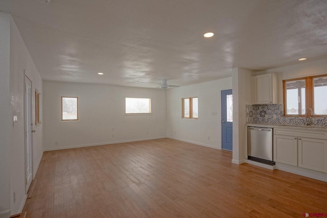 511 E Garland St, La Veta, CO 81055 - unfurnished living room featuring a sink, light wood-style flooring, healthy amount of natural light, baseboards, and recessed lighting