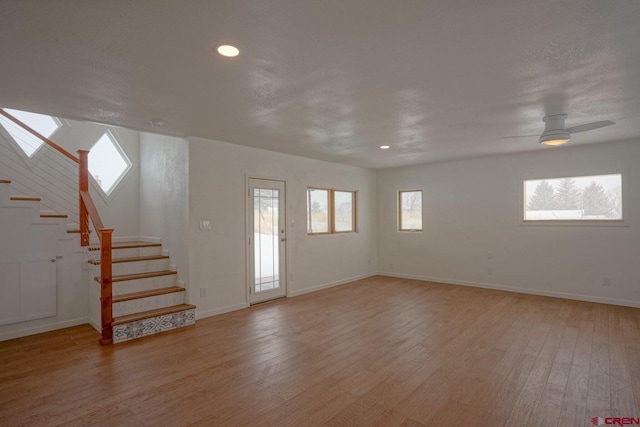 511 E Garland St, La Veta, CO 81055 - foyer featuring stairway, light wood-style flooring, a skylight, baseboards, and recessed lighting