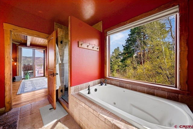 178 Valley View Rd, Ridgway, CO 81432 - full bathroom with a tub with jets, tiled shower, and plenty of natural light