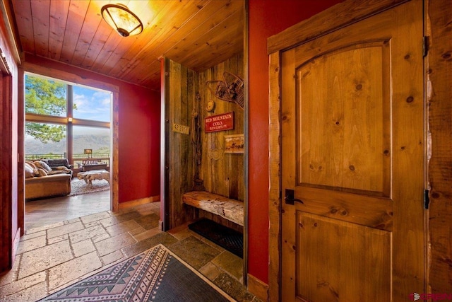 178 Valley View Rd, Ridgway, CO 81432 - mudroom featuring stone tile floors, wood ceiling, and baseboards