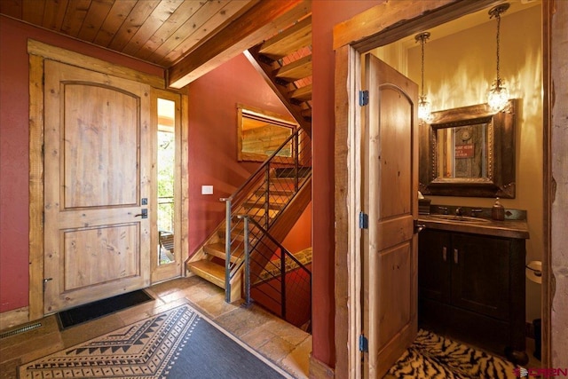 178 Valley View Rd, Ridgway, CO 81432 - foyer featuring wooden ceiling with exposed beams, stairs, and stone finish flooring