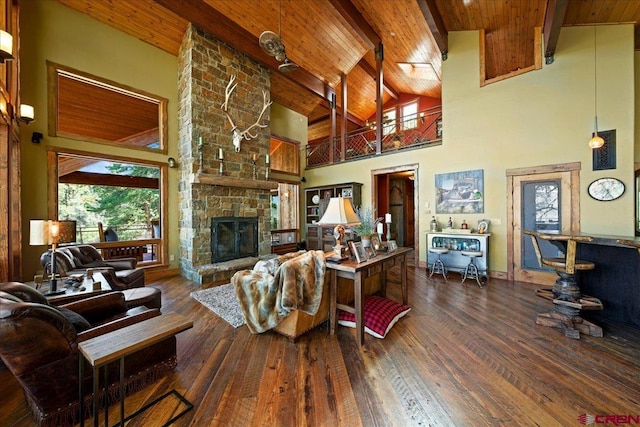 178 Valley View Rd, Ridgway, CO 81432 - living room featuring wooden ceiling with exposed beams, plenty of natural light, hardwood / wood-style flooring, high vaulted ceiling, and a stone fireplace