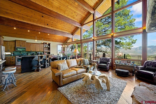 178 Valley View Rd, Ridgway, CO 81432 - living area with high vaulted ceiling, a mountain view, dark wood-style flooring, and wooden ceiling with exposed beams