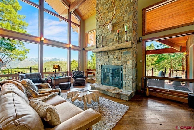 178 Valley View Rd, Ridgway, CO 81432 - living area featuring high vaulted ceiling, hardwood / wood-style flooring, wooden ceiling with exposed beams, a fireplace, and a mountain view