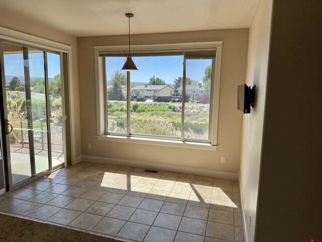1252 Peppertree Dr, Montrose, CO 81401 - unfurnished dining area with healthy amount of natural light and baseboards