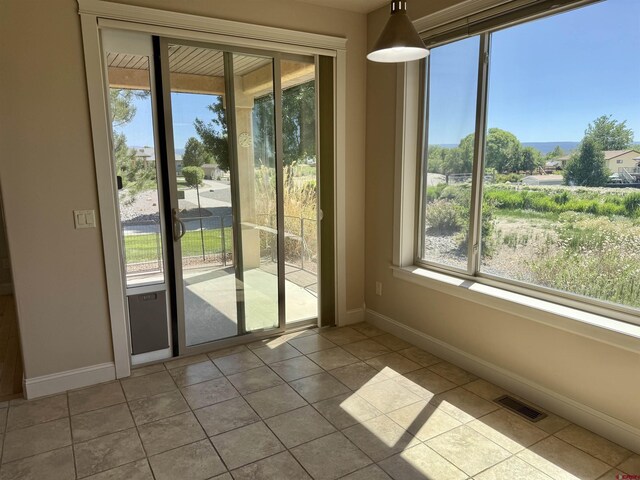 1252 Peppertree Dr, Montrose, CO 81401 - doorway to outside featuring plenty of natural light, baseboards, and tile patterned flooring