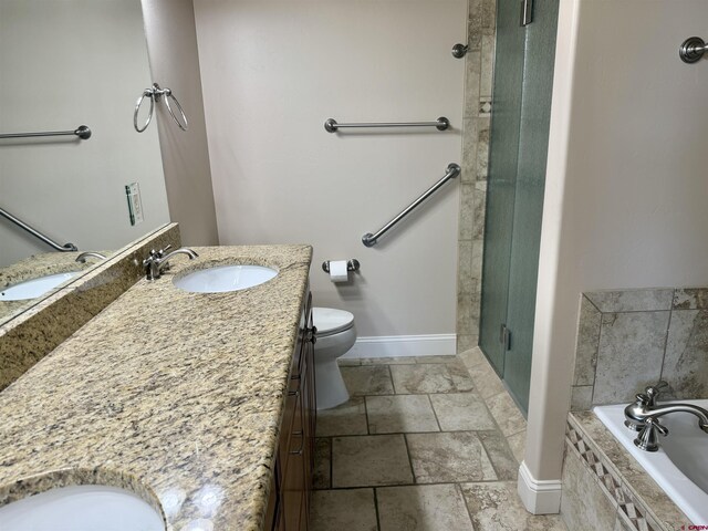 1252 Peppertree Dr, Montrose, CO 81401 - bathroom featuring vanity, a shower stall, a garden tub, baseboards, and toilet