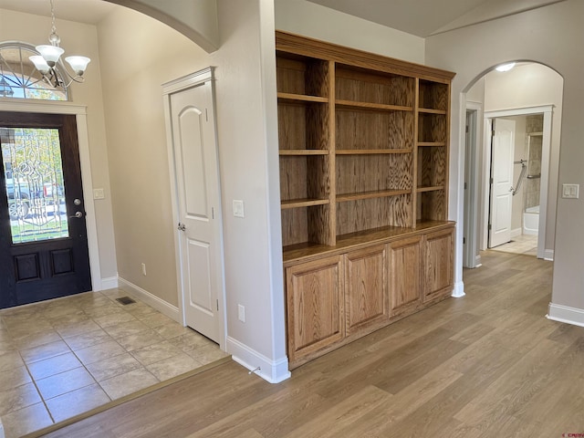 1252 Peppertree Dr, Montrose, CO 81401 - foyer entrance featuring arched walkways, a chandelier, and baseboards
